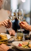 Zwei Gäste beim Abendessen mit einem Glas Wein im Restaurant des Spa Resort Geinberg